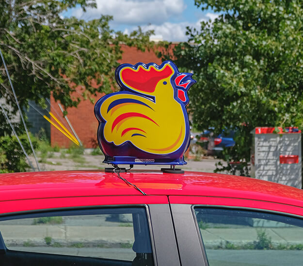 Mascot on a delivery car of Rotisseries Benny and Au Coq