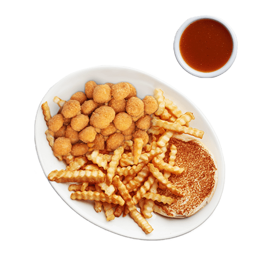 Popcorn chicken plate with fries and sauce